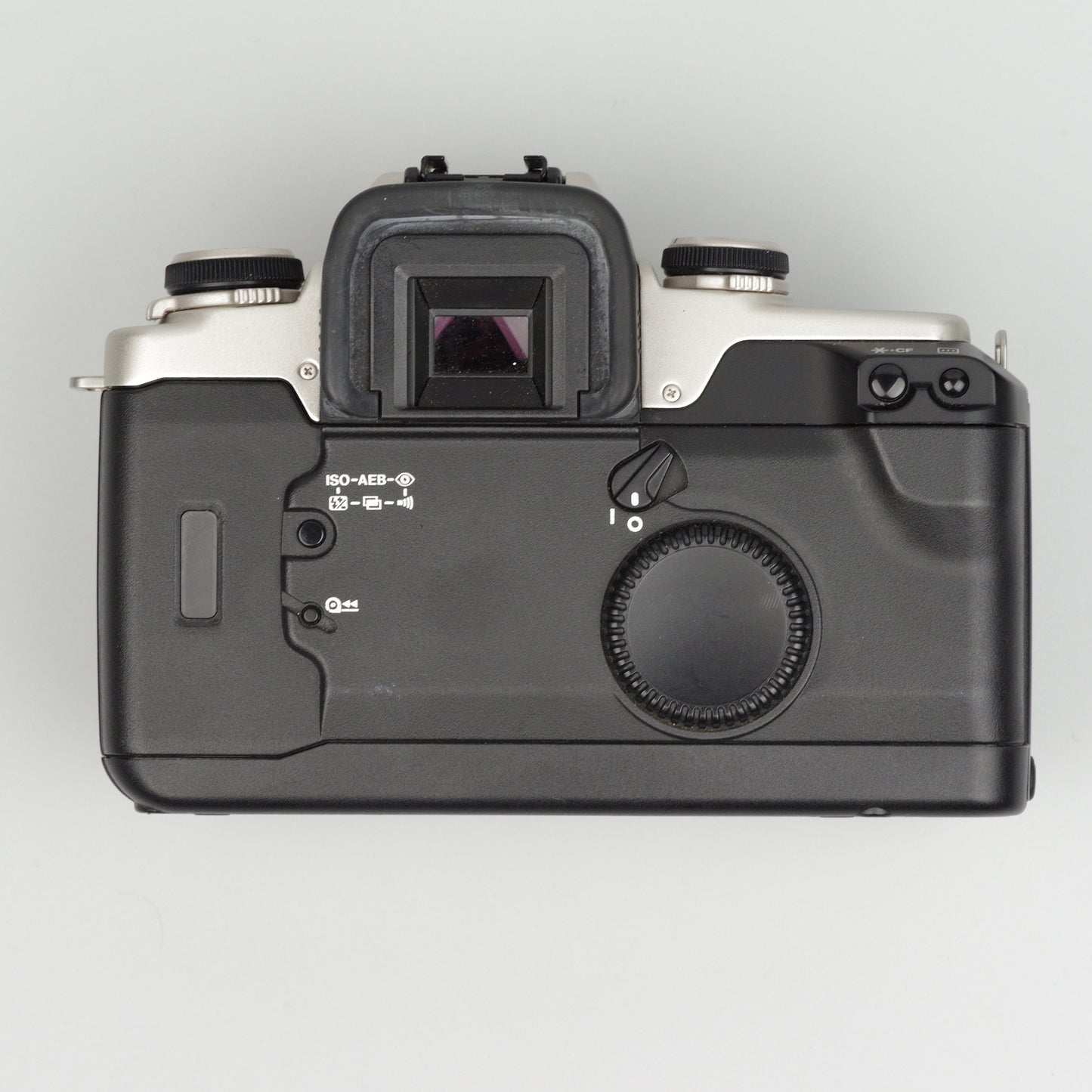 Top view of a black camera body on a light gray background