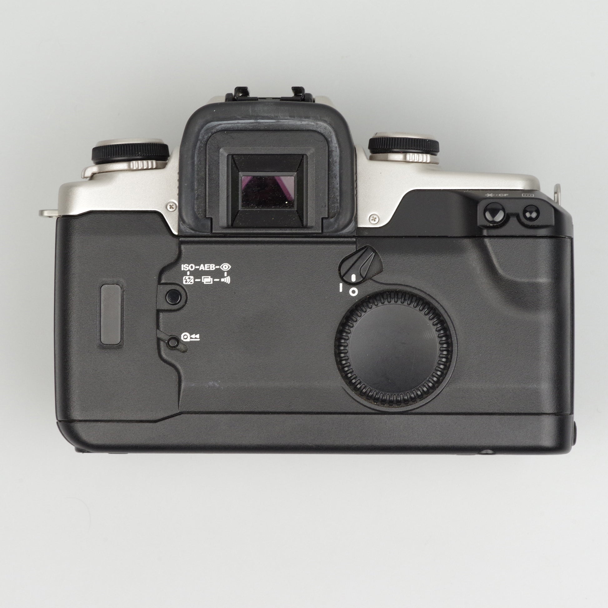 Top view of a black camera body on a light gray background